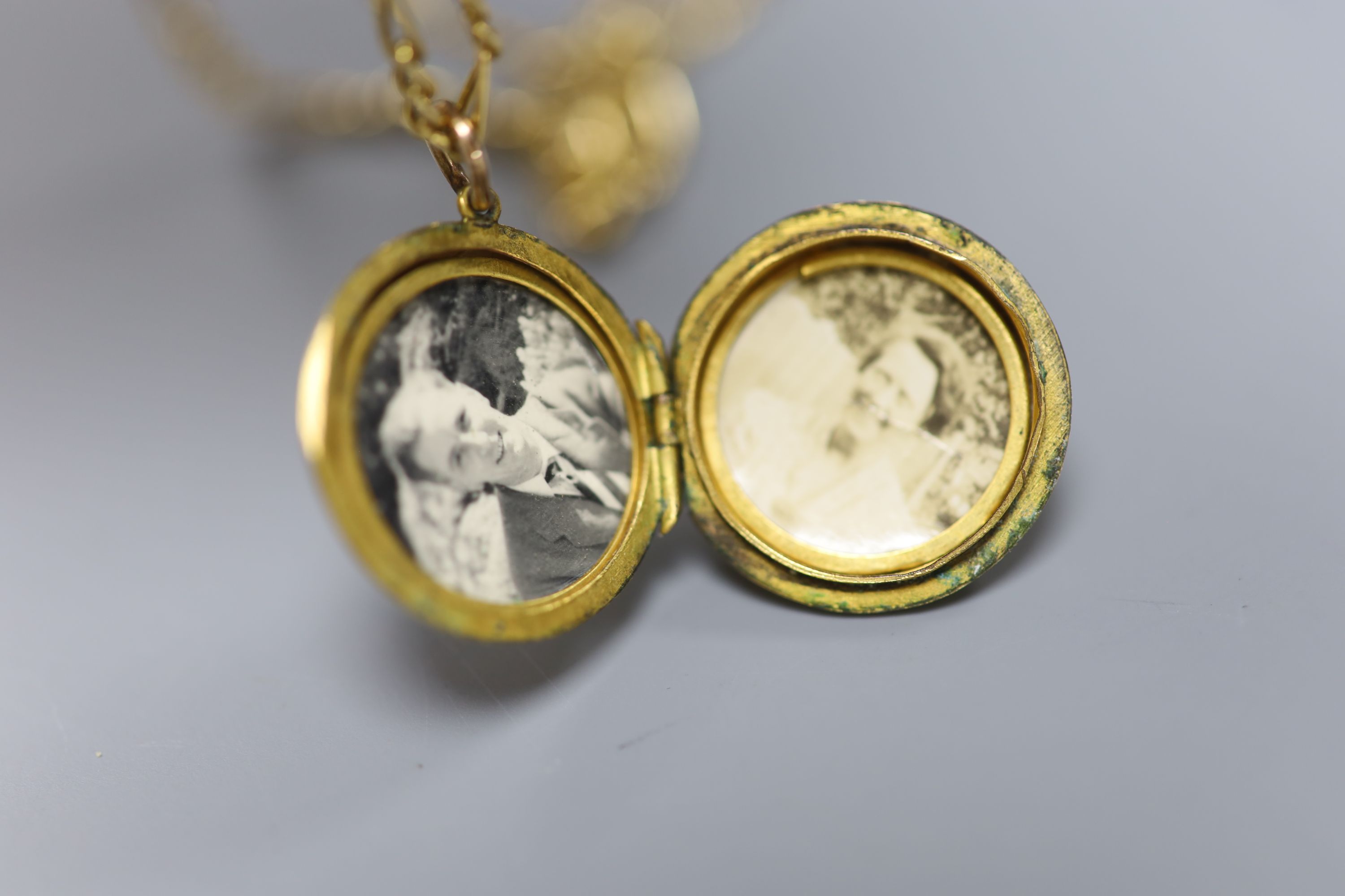 A 585 fancy link chain necklace (5.9g) with 9ct engraved gold enclosed circular locket, gross 10.7g